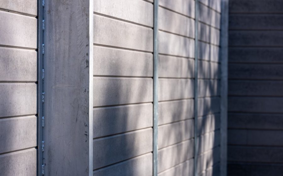 Concrete sleeper face and galvanised post, close
